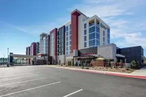 front facade of Embassy Suites and Houlihans