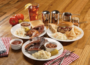 plates with ribs, potato salad, baked beens, fries, and barbecue sandwich
