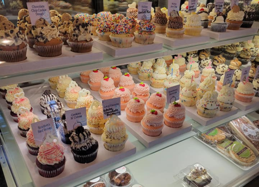 bakery shelves filled with various cupcakes