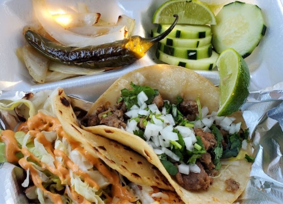 close up of street tacos with cucumber and lime